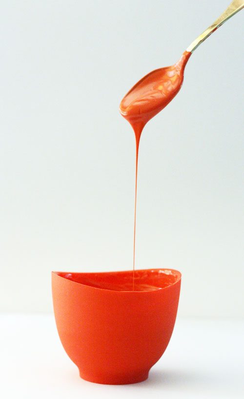 Melted Red Chocolate Dripping Into a Bowl